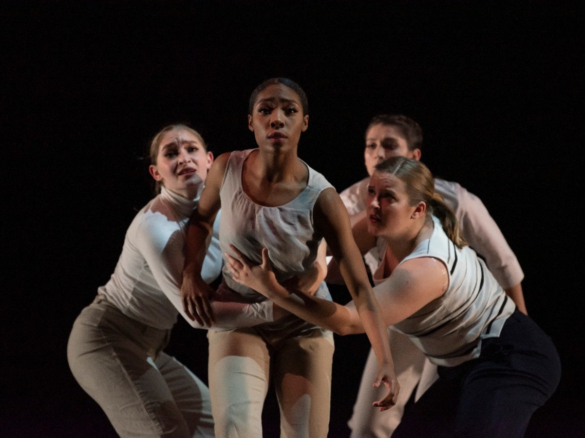 Dancers in front of a black backdrop
