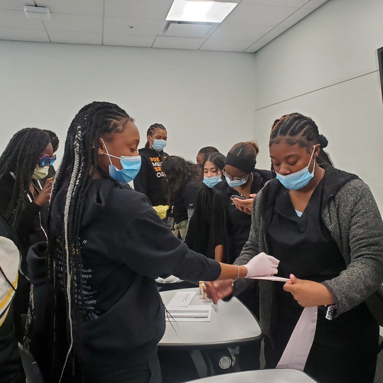 Students practicing compressions on CPR dummies.